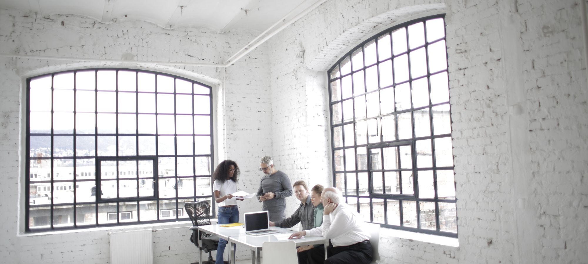 Team collaborating around a table in a bright minimal studio